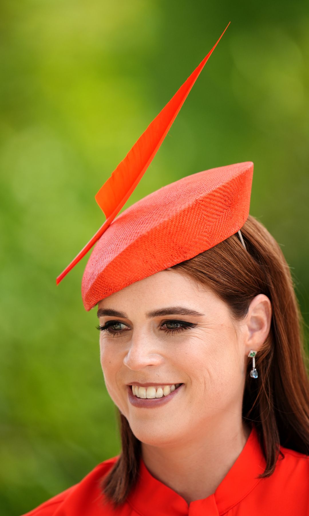 Princess Eugenie smiling neck up in red hat