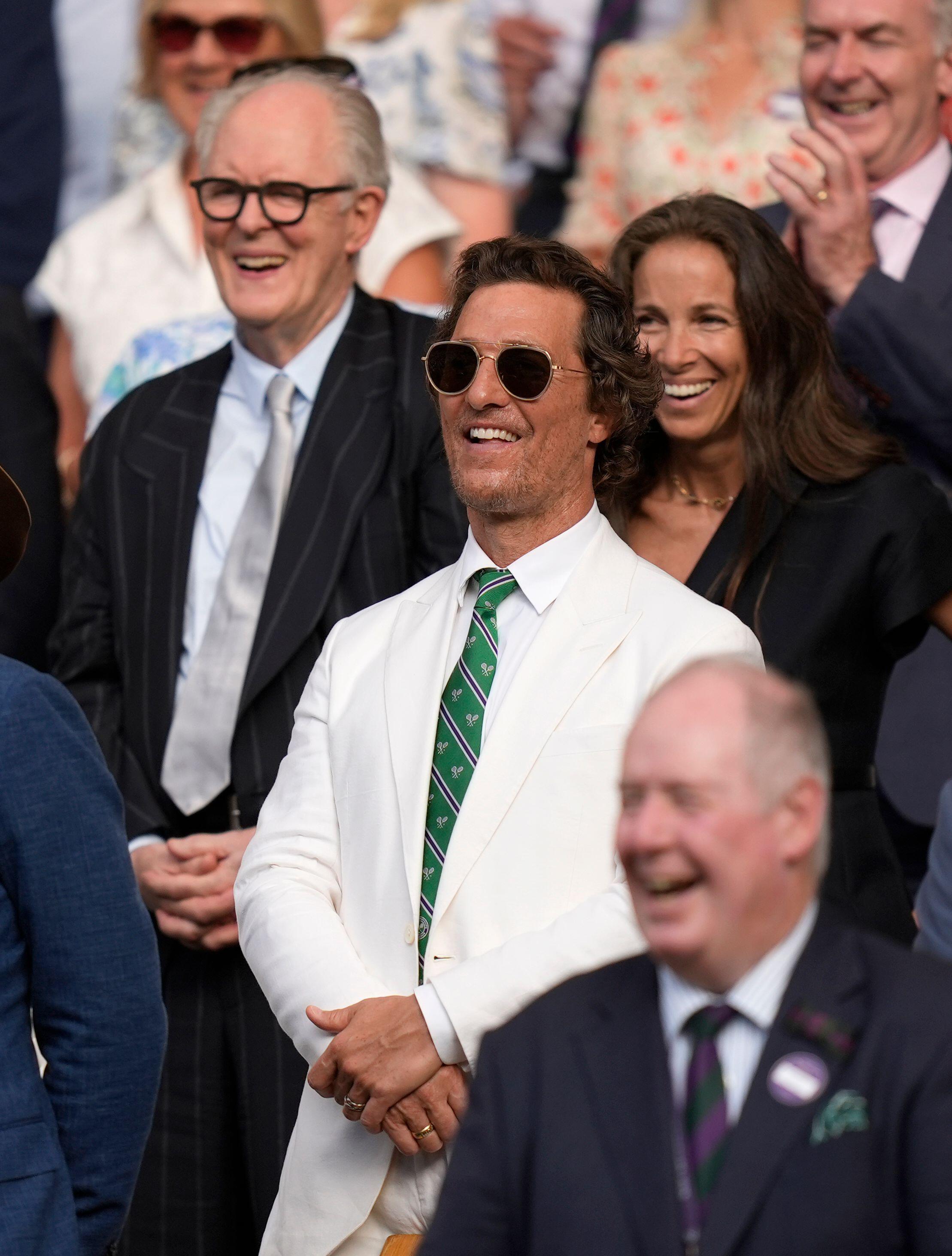 Matthew Mcconaughey in a very nice white linen suit enjoys wimbledon