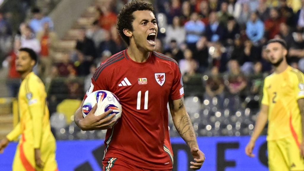 Brennan Johnson shouts in celebration while holding the ball after equalising against Belgium in Brussels in June 2025