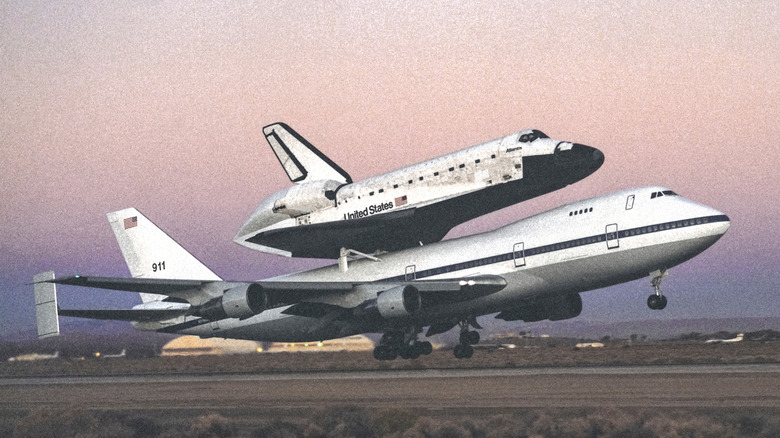 An SCA carries a space shuttle over the mountains of California