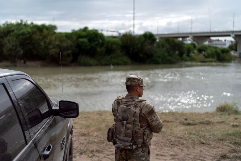 An Army Reserve soldier watches over the Rio Grande river separating Mexico from the US in Laredo, Texas, on Tuesday.