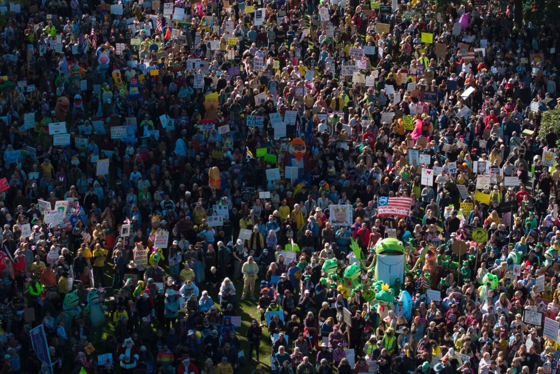 People gather along a waterfront park during a