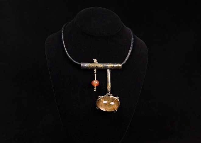 -- This undated photo provided by the Oakland Museum of California Thursday, Oct. 30, 2025, shows the Rutilated Quartz Dome Neckpiece by Florence Resnikoff at the Oakland Museum of California, in Oakland, Calif. (Leopold Macaya/Oakland Museum of California via AP)