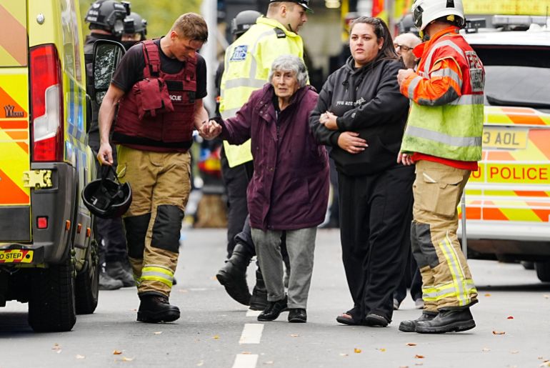 A member of the public is helped from the scene of a stabbing incident at Heaton Park Hebrew Congregation synagogue, in Crumpsall, Manchester, England, Thursday Oct. 2, 2025. (Peter Byrne/PA via AP)
