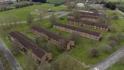 PA Media An aerial picture of MDP Wethersfield. There are seven blocks of accommodation, which are two-storeys. There are grassy areas and trees.
