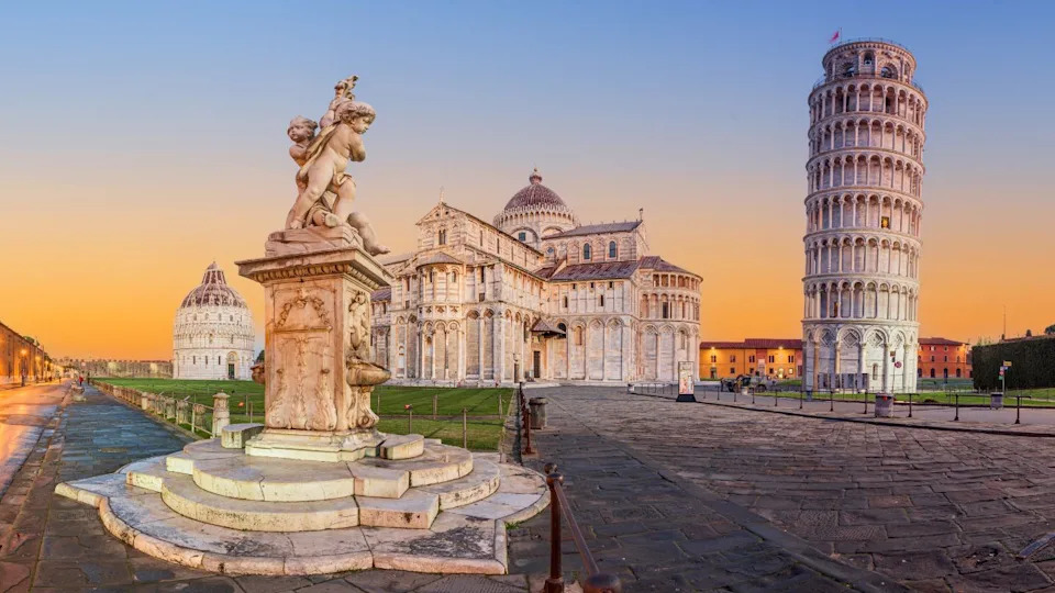 PISA, ITALY - DECEMBER 17, 2021: The Leaning Tower of Pisa in the Square of Miracles at twilight.
