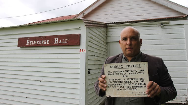 Belvedere Hall in Carterton is on the market. Council communications and engagement manager Marcus Anselm is pictured holding a placard outside the front of the building last year. (Source: LDR / Emily Ireland)