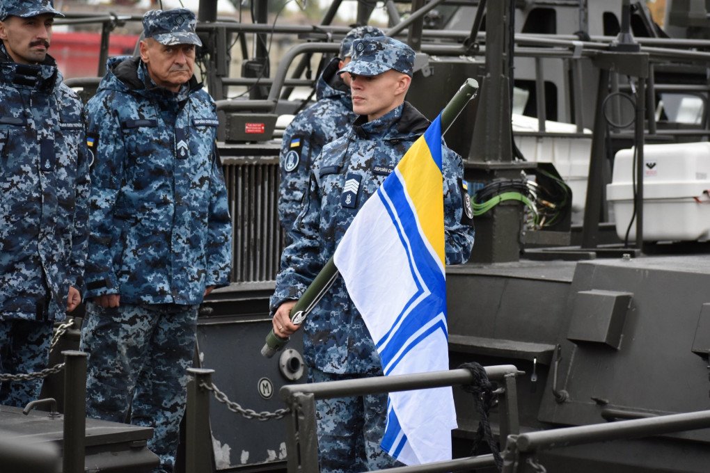 Ukrainian naval personnel stand on the deck of a CB90 boat during a flag ceremony. (Source: Ukrainian Navy)