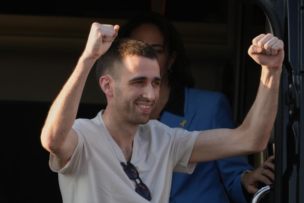 Freed Israeli hostage Avinatan Or gestures from a van as...
