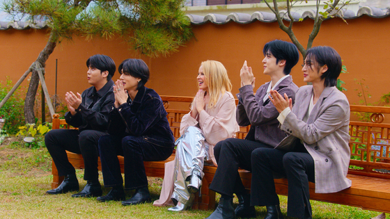 Boy band Ateez and singer Kylie Minogue watch a traditional Korean dance performance from Apple TV+'s ″KPOPPED″ [APPLE TV+]