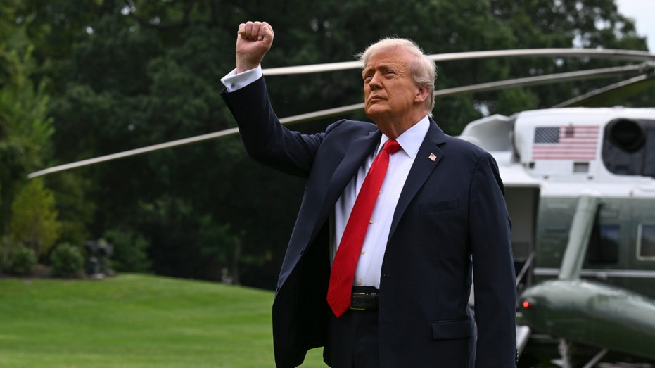 President Donald Trump pumps his fist before boarding Marine One.