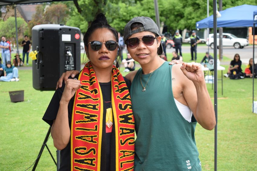 two people with fists raised
