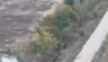 Russian assault troops on motorcycles crash one after another into a destroyed vehicle, blindly riding through smoke