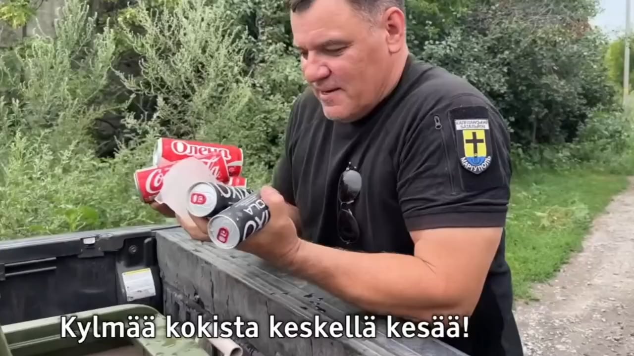 A Finnish reporter and his Ukrainian buddy bring cold Coca-Cola to Ukrainian soldiers who just returned from a fight