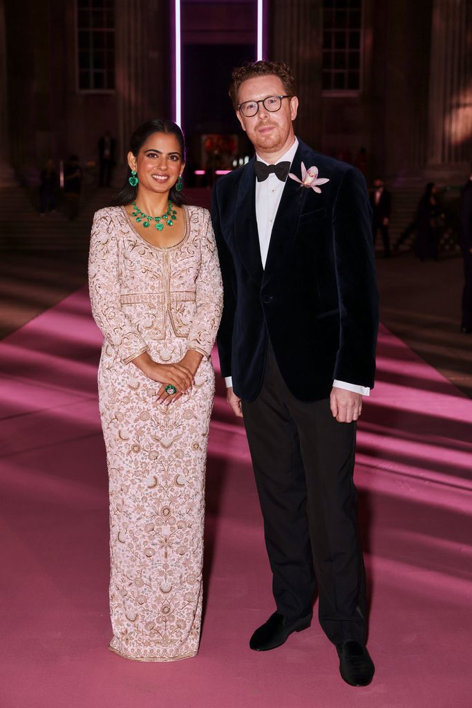 Isha Ambani posed in embellished blush dress beside man in tuxedo