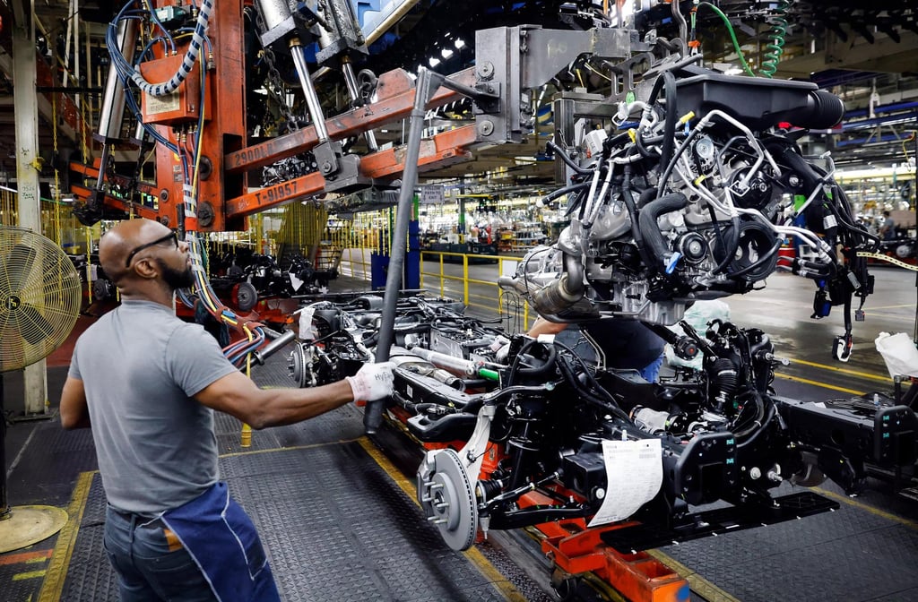 An assembly team worker lowers an engine assembly onto the frame of a large SUV at the General Motors Arlington Assembly plant on June 8, 2023, in Arlington, Texas. Photo: The Dallas Morning News / TNS An assembly team worker lowers an engine assembly onto the frame of a large SUV at the General Motors Arlington Assembly plant on June 8, 2023, in Arlington, Texas. Photo: The Dallas Morning News / TNS