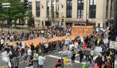 People carried a large copy of the US Constitution as they march through downtown Chicago during the No Kings protests.