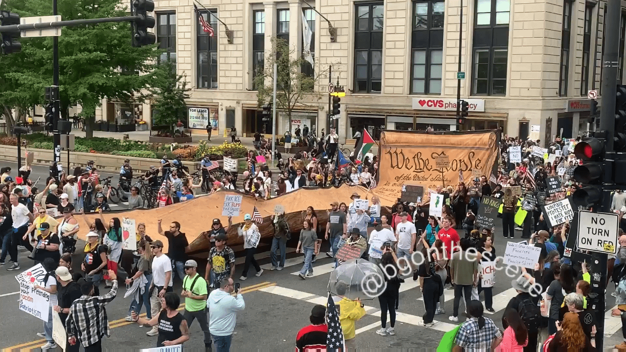 People carried a large copy of the US Constitution as they march through downtown Chicago during the No Kings protests.