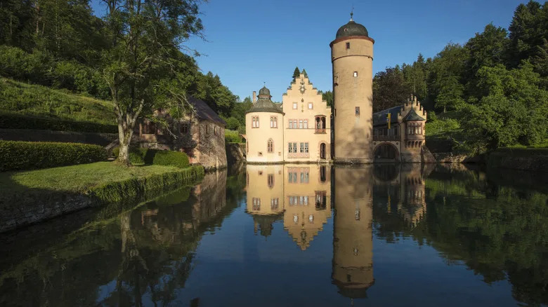 Mespelbrunn Castle surrounded by a moat reflecting in the water