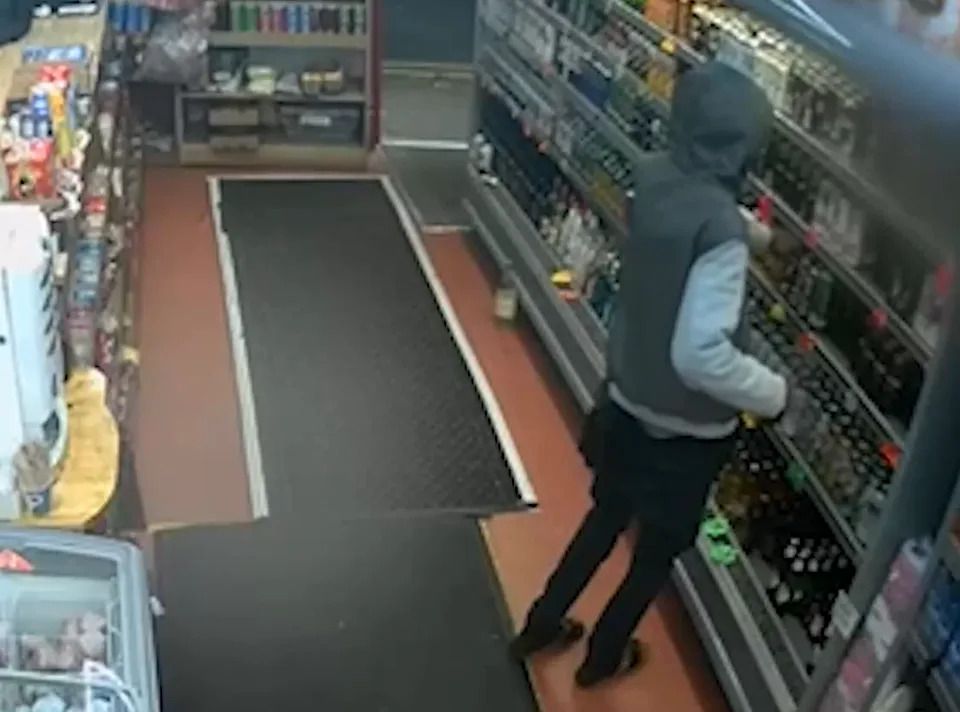 Still of a man said to be Deng Majek buying alcohol