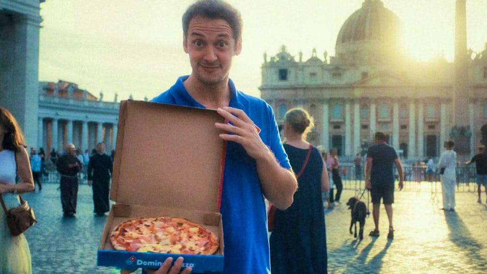 Nice try: the pizza giant asks for divine blessing for its pineapple topping by going through the Holy Door of the Vatican.