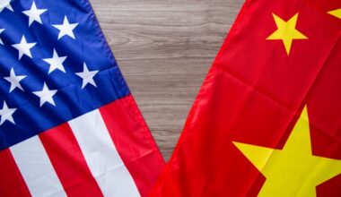The flags of the United States and China, overlapped on a table.