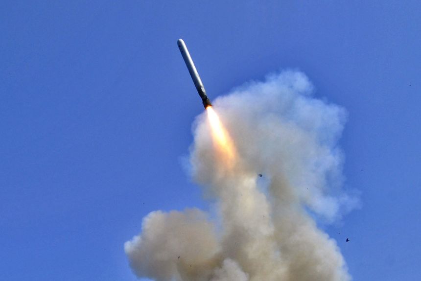 AT SEA - MARCH 29, 2011: In this handout released by the US Navy, the US Navy guided-missile destroyer USS Barry launches a Tomahawk cruise missile from the Mediterranean Sea, on March 29, 2011.
