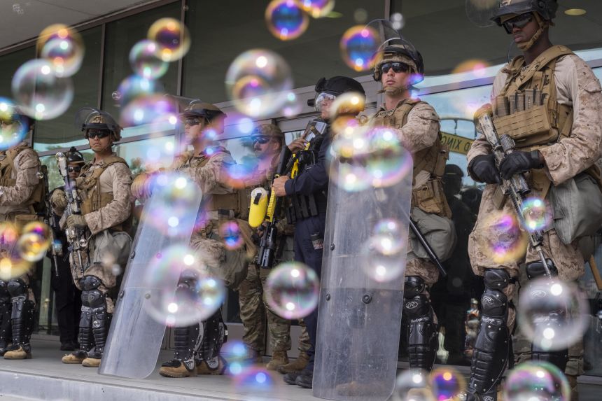 Bubbles float past US Marines during a 