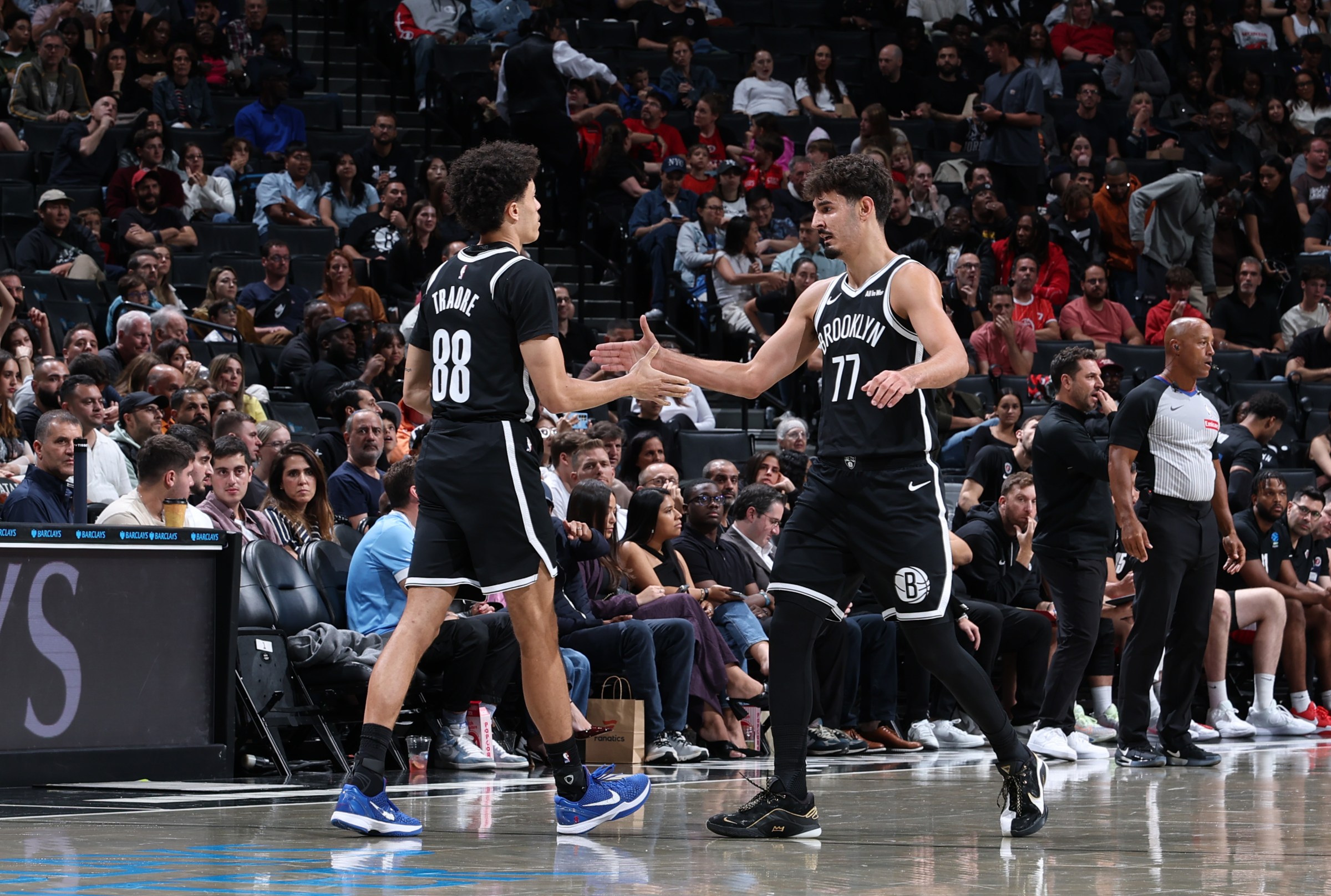 BROOKLYN, NY - OCTOBER 4: Nolan Traore #88 and Ben Saraf #77 of the Brooklyn Nets high five during the game against Hapoel Jerusalem B.C during Preseason on October 4, 2025 at Barclays Center in Brooklyn, New York. NOTE TO USER: User expressly acknowledges and agrees that, by downloading and or using this photograph, User is consenting to the terms and conditions of the Getty Images License Agreement. Mandatory Copyright Notice: Copyright 2025 NBAE (Photo by David L. Nemec/NBAE via Getty Images)