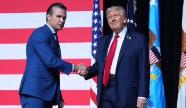 President Donald Trump is greeted by Secretary of Defense Pete Hegseth before speaking to a gathering of top U.S. military commanders at Marine Corps Base Quantico, Tuesday, Sept. 30, 2025, in Quantico, Va. (AP Photo/Evan Vucci)