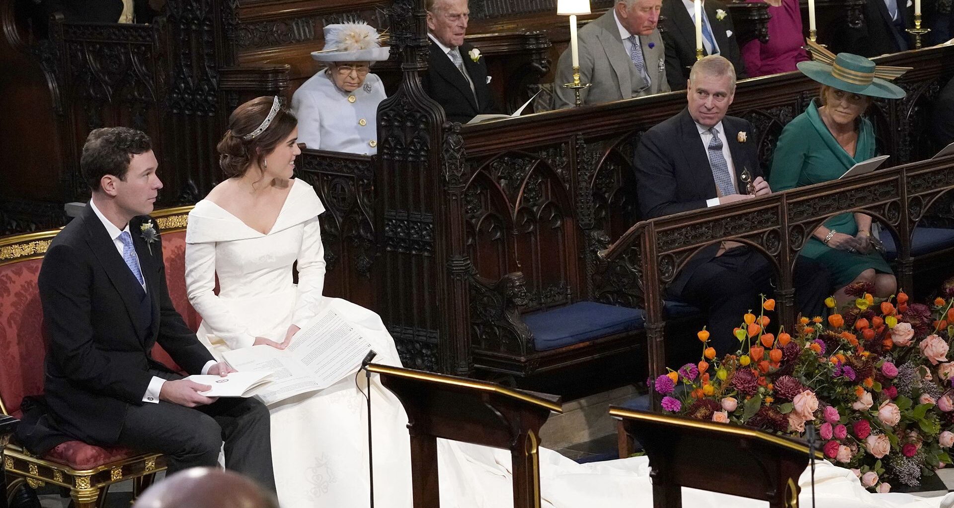 WINDSOR, ENGLAND - OCTOBER 12: Princess Eugenie and her husband Jack Brooksbank, look back towards the Duke of York and Sarah, Duchess of York (seated front) and Queen Elizabeth II, the Duke of Edinburgh, Prince of Wales, the Duke and Duchess of Cambridge, and the Duke and Duchess of Sussex, during their wedding at St George's Chapel in Windsor Castle on October 12, 2018 in Windsor, England. (Photo by Danny Lawson - WPA Pool/Getty Images)