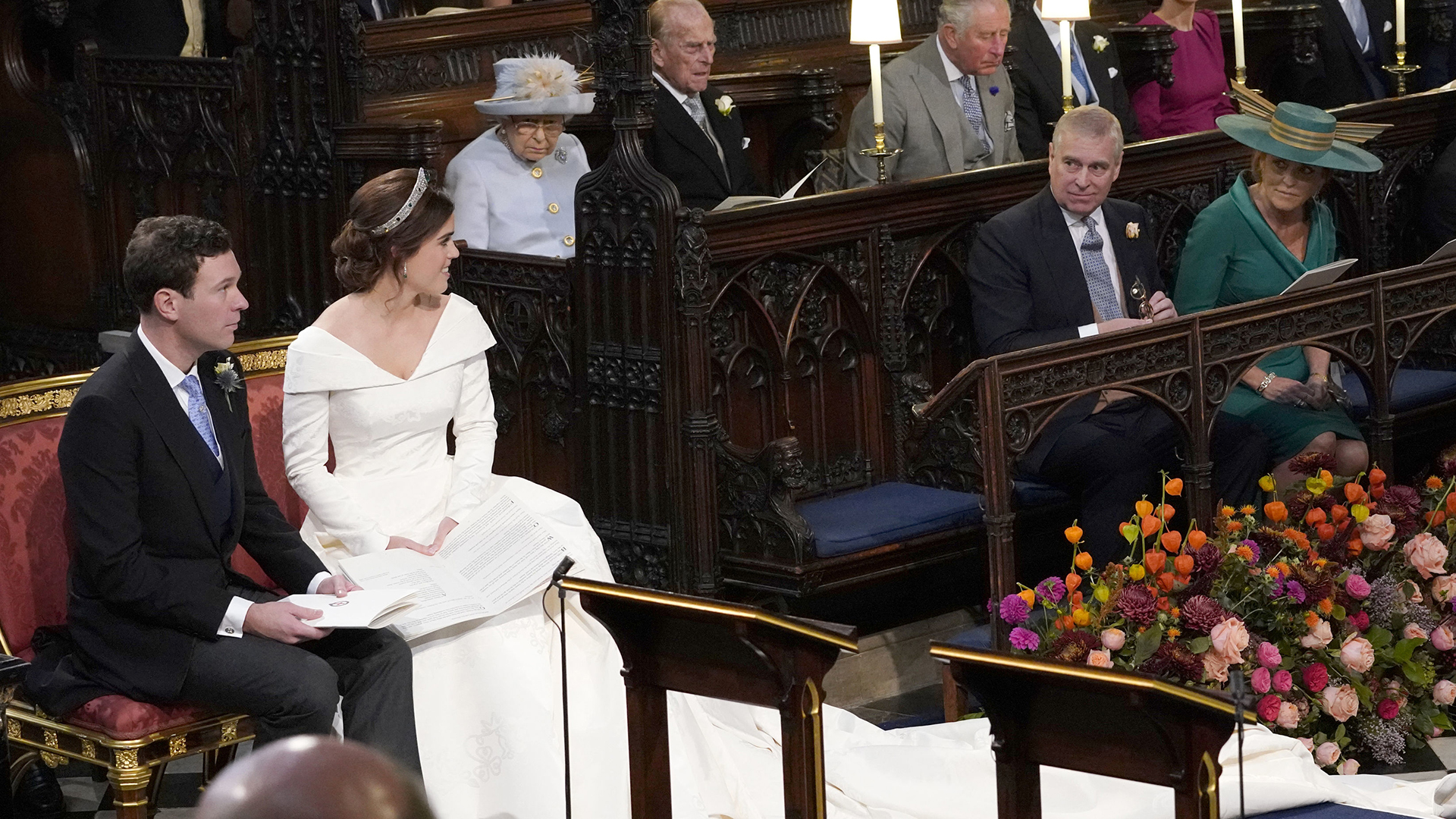 WINDSOR, ENGLAND - OCTOBER 12: Princess Eugenie and her husband Jack Brooksbank, look back towards the Duke of York and Sarah, Duchess of York (seated front) and Queen Elizabeth II, the Duke of Edinburgh, Prince of Wales, the Duke and Duchess of Cambridge, and the Duke and Duchess of Sussex, during their wedding at St George's Chapel in Windsor Castle on October 12, 2018 in Windsor, England. (Photo by Danny Lawson - WPA Pool/Getty Images)