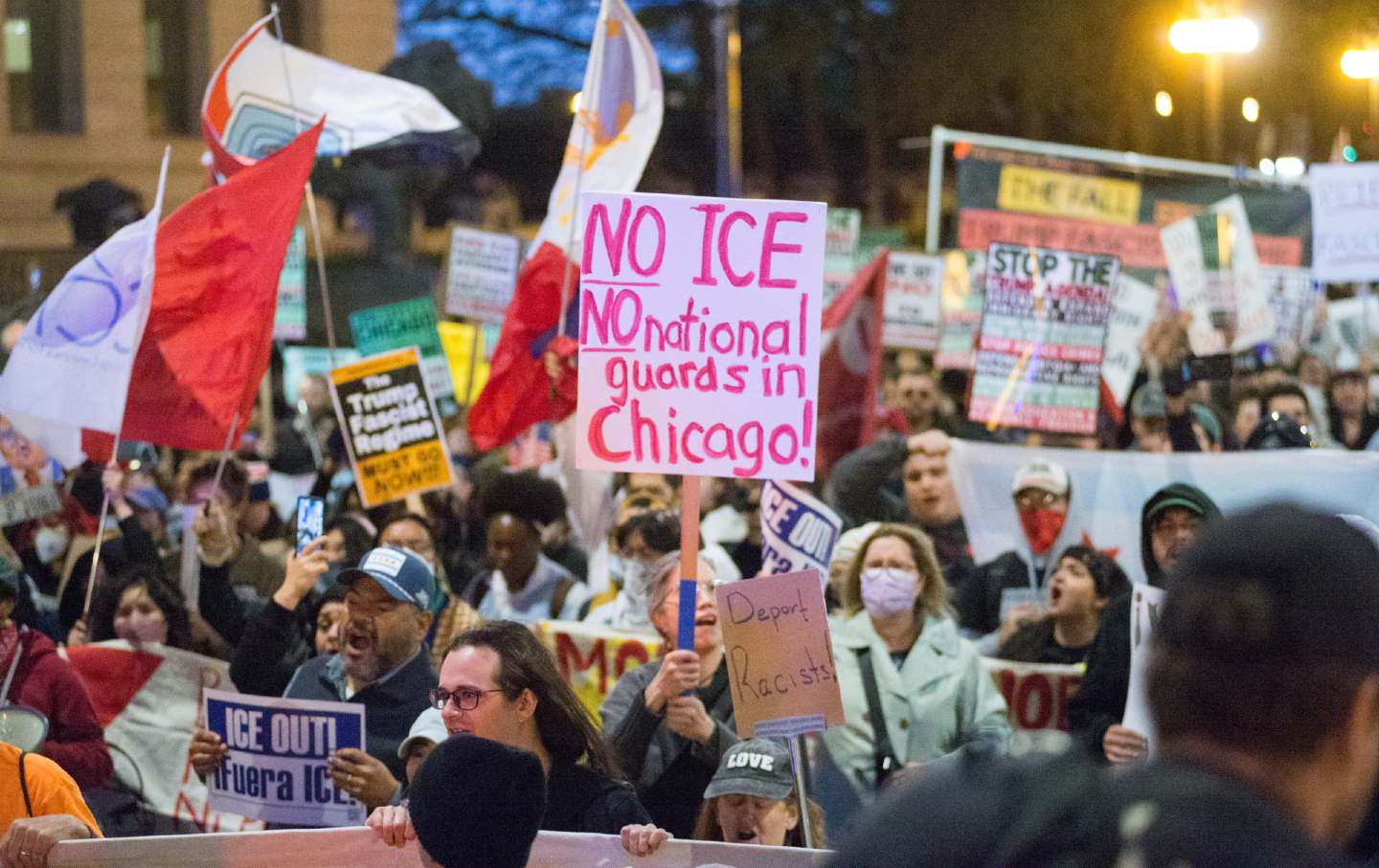 Crowds gather at Ida B. Wells Drive and Michigan Avenue in downtown Chicago, Illinois, on October 8, 2025, for an emergency rally, waving flags and holding signs to oppose ICE and National Guard presence in Chicago.