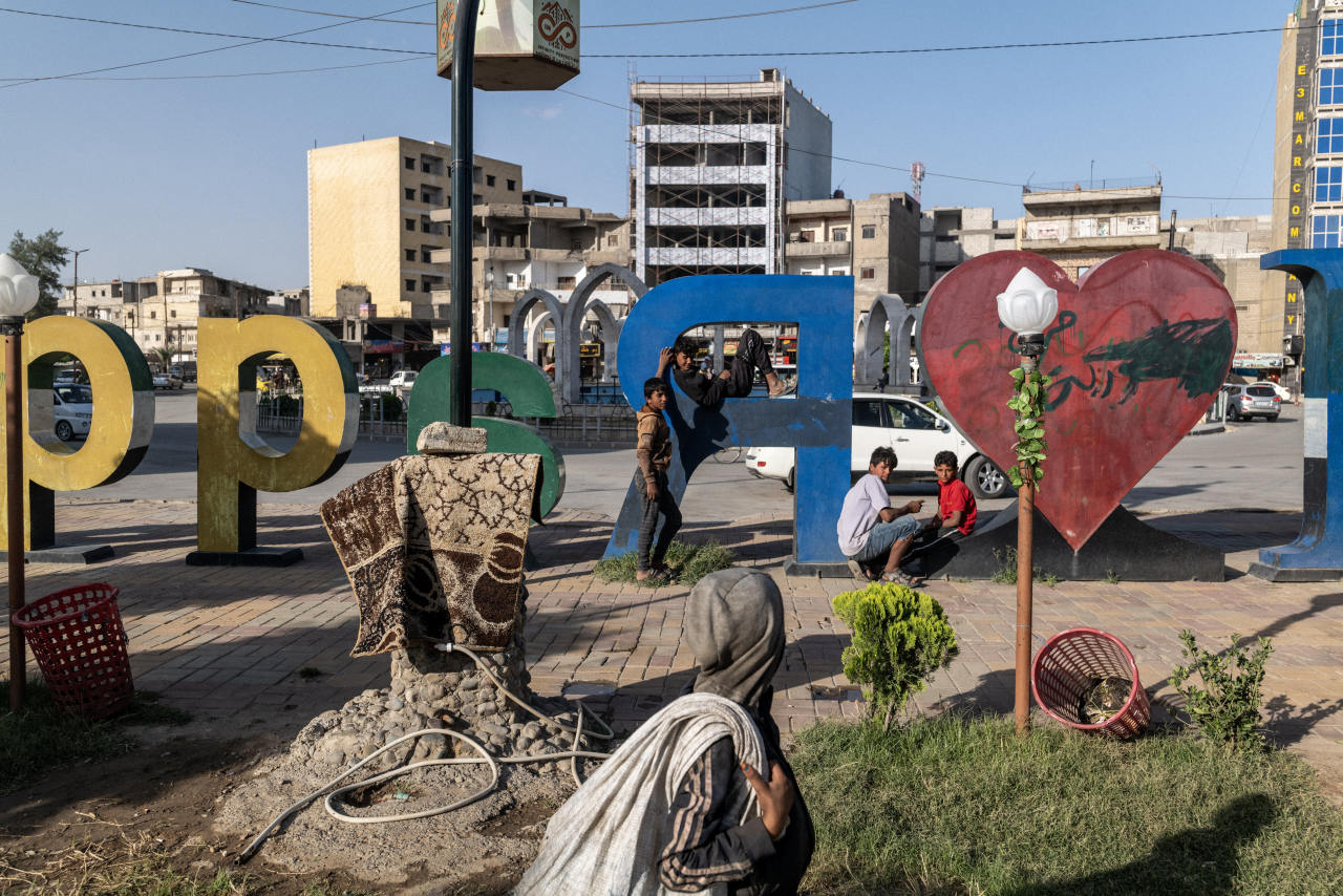 Children took a break from collecting garbage and begging in Naim Square in Raqqa, Syria. Children took a break from collecting garbage and begging in Naim Square in Raqqa, Syria.