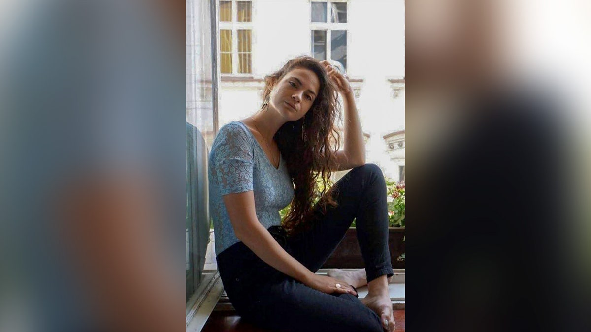 Inbar Hayman sits on a windowsill