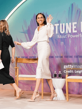 Meghan wears leather skirt from Brochu Walker and blouse from Gabriela Hurst