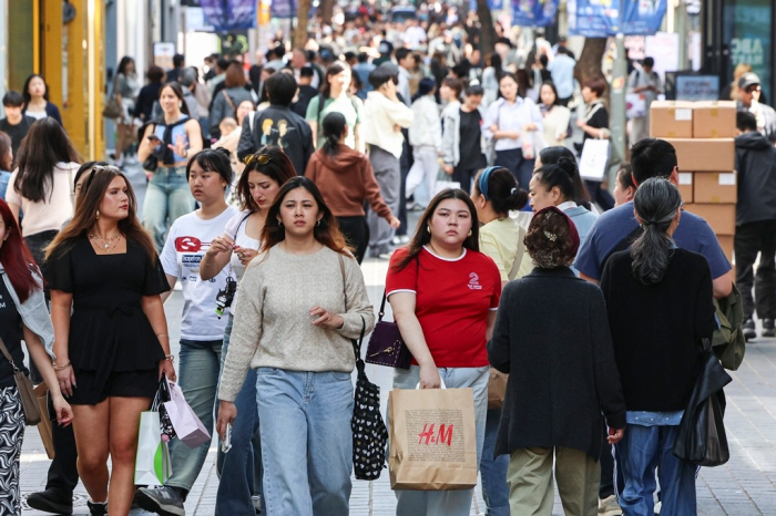 Tourists in Myeong-dong, a popular shopping street in Seoul