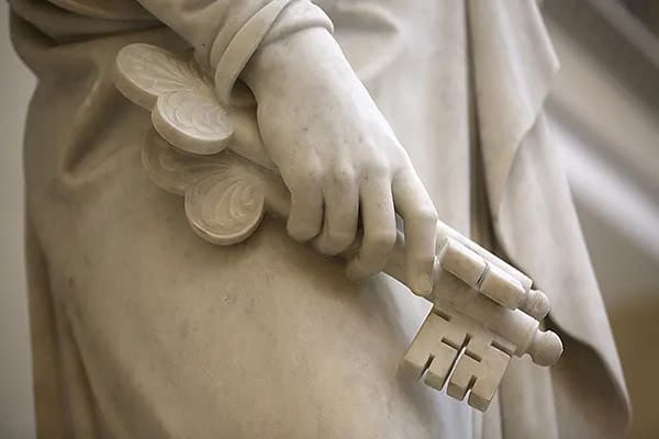 Marble statue holding symbolic keys, representing apostolic succession and priesthood keys of authority.