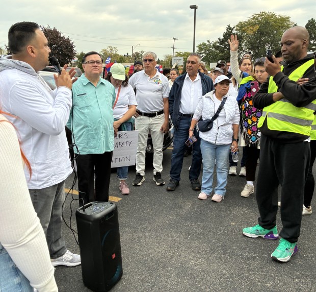 Before more than 300 marchers left Corrine J. Rose Park to walk nearly two miles to City Hall, they joined in prayer Monday in Waukegan. (Steve Sadin/For the Lake County News-Sun)