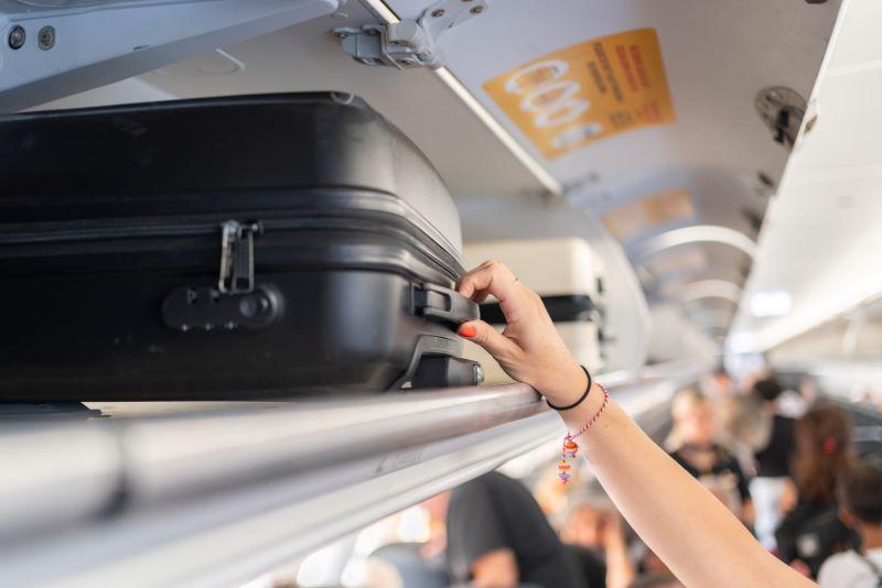luggage in an overhead compartment in the airplane