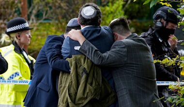 Members of the Jewish community comfort each other near to the Heaton Park Hebrew Congregation synagogue, in Crumpsall, Manchester, England, Thursday, Oct. 2, 2025 after Police reported that two people were killed and three others were seriously injured in a synagogue attack in northern England. (Peter Byrne/PA via AP)
