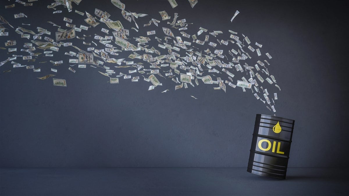 money flying out of an oil drum