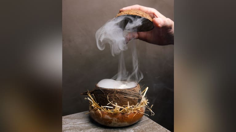 One of TALA’s signature dishes, presented in a coconut shell with smoke - a nod to traditional Sāmoan cooking and storytelling through food.