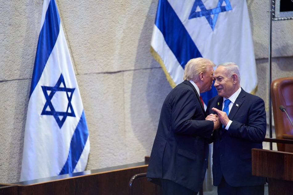US President Donald Trump (l.) talks with Israel's Prime Minister Benjamin Netanyahu at the Knesset on October 13, 2025