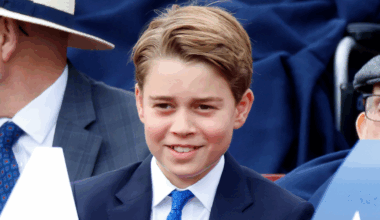 Prince George wearing a blue suit and smiling