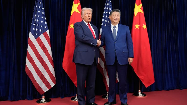 President Donald Trump, left, and Chinese President Xi Jinping, right, shake hands before their meeting at Gimhae International Airport in Busan, South Korea.