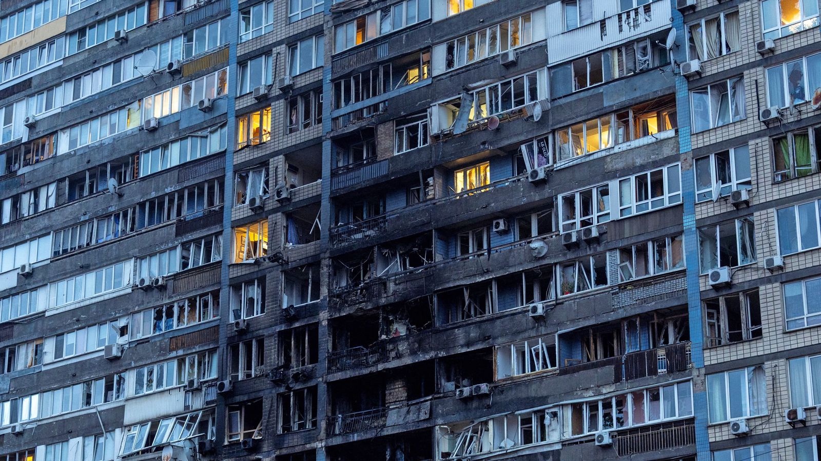 A block of flats in Kyiv caught fire after being hit. Pic: Reuters