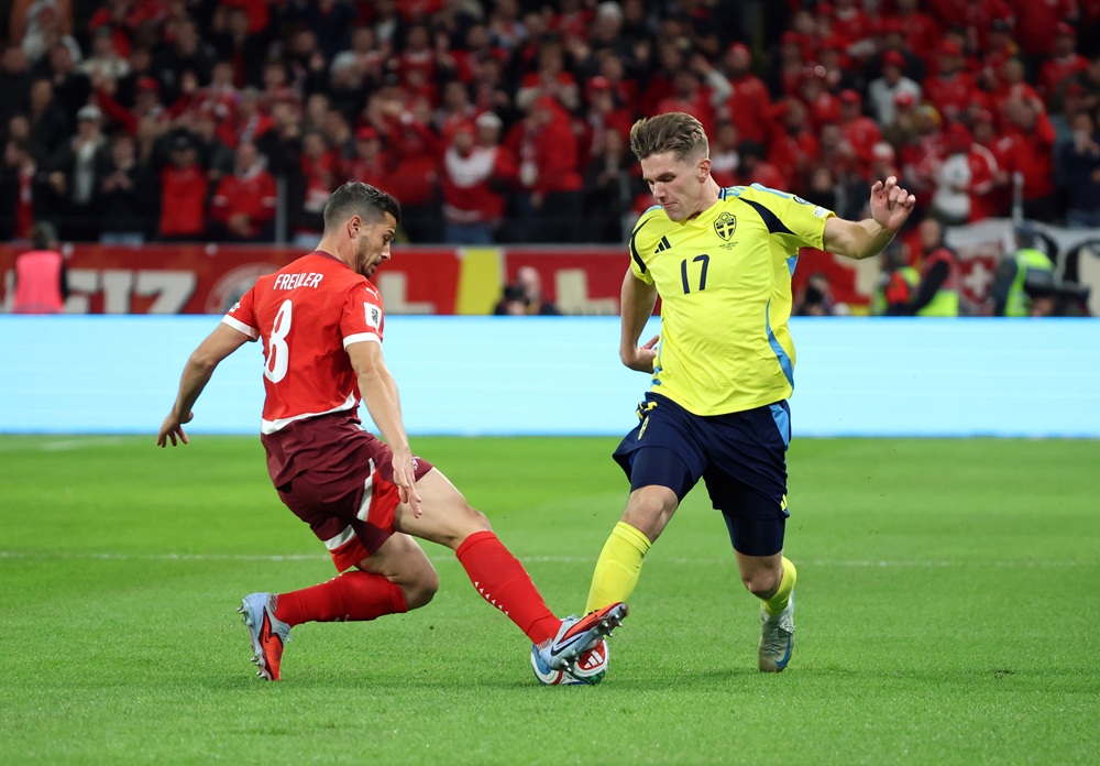 SOLNA, SWEDEN: Viktor Gyoekeres of Sweden battles for possession with Remo Freuler of Switzerland during the FIFA World Cup 2026 Qualifier match be...