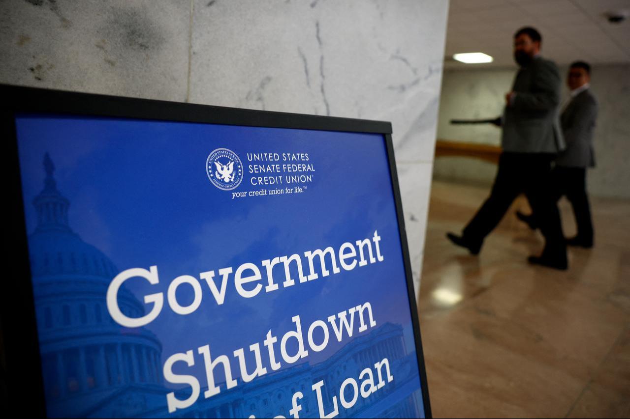 A sign advertising a government shutdown relief loan is seen outside of the U.S. Senate Federal Credit Union, Sept. 30, 2025, in Washington, DC. (AFP Photo)