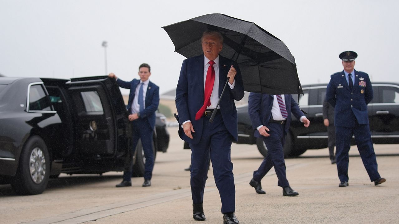 President Donald Trump walks over to speak with reporters before boarding Air Force One, Sunday, Oct. 12, 2025, at Joint Base Andrews, Md., as he heads to the Middle East. (AP Photo/Evan Vucci)